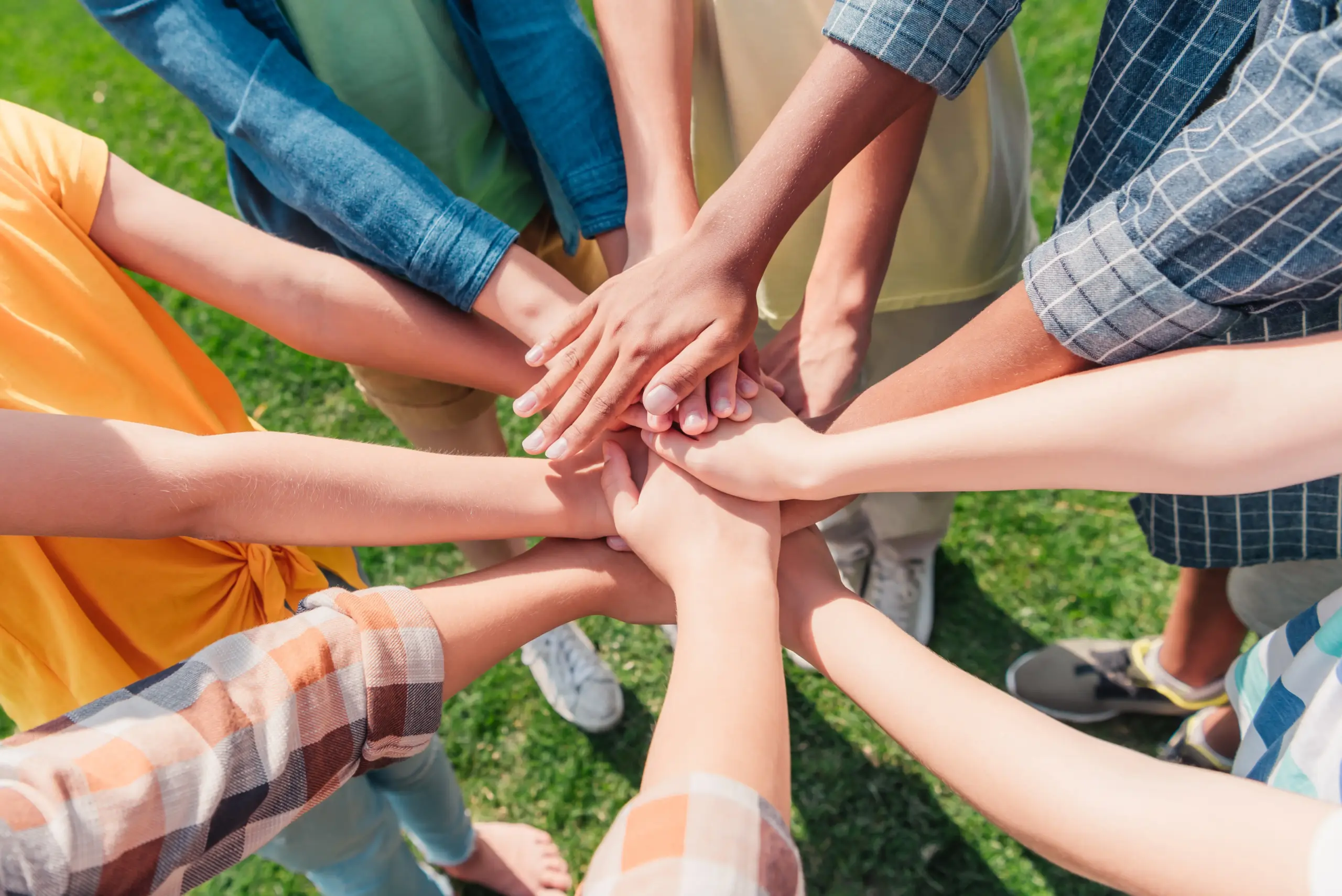 Young people holding hands together in the park